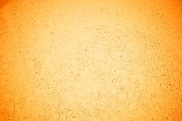 Rain droplets on yellow glass background, Water drops on yellow glass.