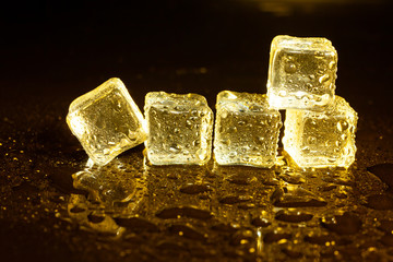 ice cubes on a reflections yellow light.
