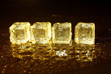 ice cubes on a reflections yellow light.