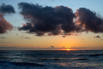 sunset over the sea with dark clouds