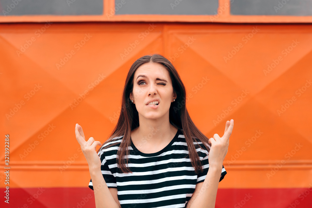 Wall mural Funny Woman with Fingers Crossed Making a Wish