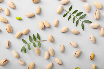 Tasty pistachio nuts on light background