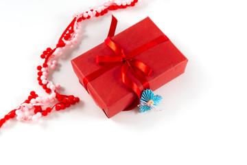 Red gift box with heart and bow on white background. Valentines day 14 february packaging concept.