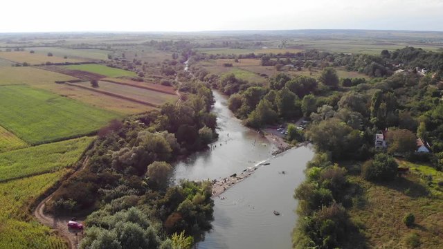 Drone Aerial Romania countryside river trees swamp green fields