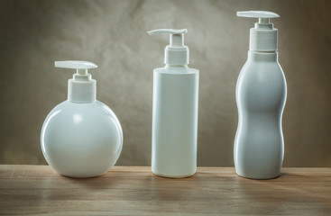 body hygiene products three pump dispensers mockup blank white plastic bottles
