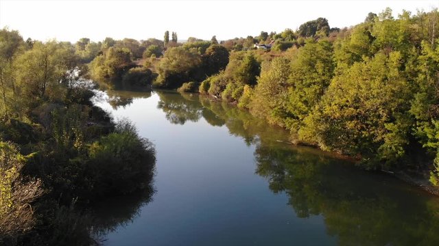 Drone Aerial Romania countryside river trees swamp green fields above autumn