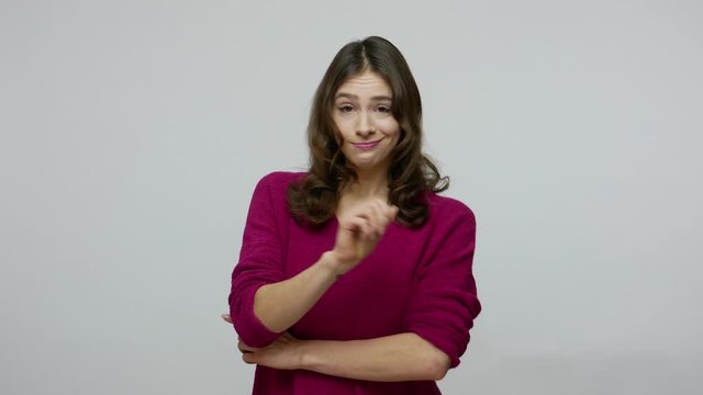 No, I told you! Nice beautiful brunette woman in pullover waving finger in admonishing gesture, warning to do wrong, alarming and looking with serious bossy expression. studio shot gray background