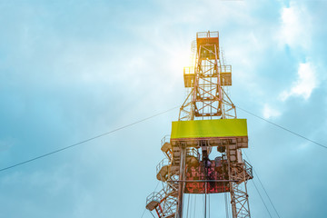 Oil and Gas Drilling Rig onshore dessert with dramatic cloudscape. Oil drilling rig operation on...