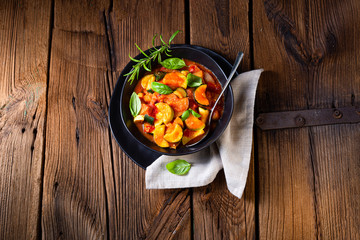 zucchini vegetarian ratatouille with tomato sauce and herbs
