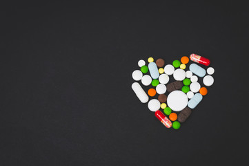 heart of multicolored tablets close-up