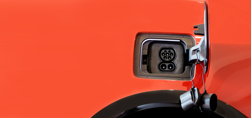 Charge port on an electric car with copy space on background.