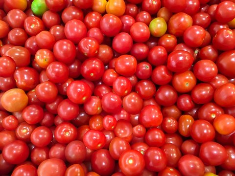 Fresh seeda tomatoes set as a background in market.Healthy eating.Small tomato