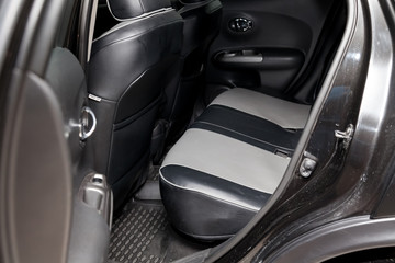 Clean after washing the rear passenger seats of black and gray genuine leather inside the interior...