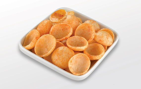 Fried and Spicy Moon Cup, Vatka, Katori, Moon Chips, Snacks or Fryums (Snacks Pellets) served in a bowl or White background. selective focus - Image