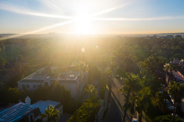 Stunning aerial view of Beverly Hills neighborhood, Beverly Hills Hotel, and Sunset Boulevard surrounded with palm trees in Los Angeles, California.
