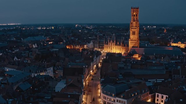 Belgium, Bruges: night typical view of tower of Belfort Van Brugge and market Square with Provinciaal Hof (Province Court)