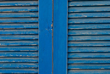 Obraz na płótnie Canvas Trend blue color 2020 closed shutters, old window close up. Trendy color concept of the year, classic wood background.