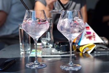 Closeup of cocktail in elegant glasses - group of people toasting