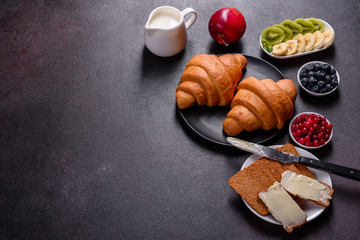 Delicious breakfast with fresh croissants and ripe berries