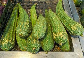 Green zucchini in the market as a background