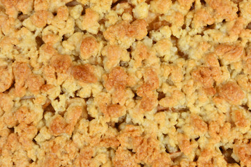 Cake topping crumbles on European Apple pie, close up