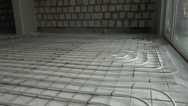 Construction industry. Room with underfloor heating system pipes