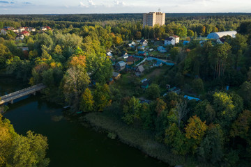 Fototapeta premium The bridge in the village over the pond on a summer evening