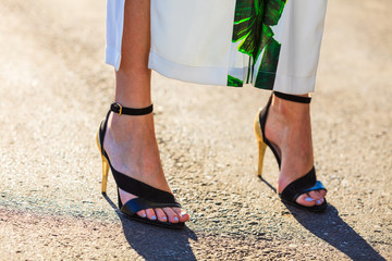 Woman feet in high heels summer shoes.