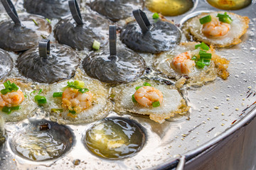 Sizzling Vietnamese shrimp and onion tiny pancake on skillet