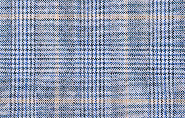 Beige Glenurquhart check is made of blue woolen fabric. Classic  Wool Background Texture. Coat close-up. Expensive men's suit