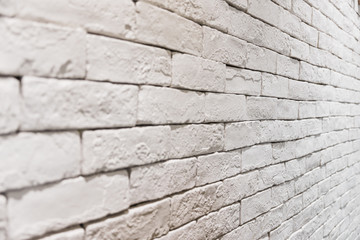 side view of empty white brick wall in room. textured and background