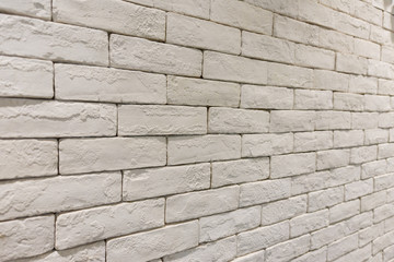 side view of empty white brick wall in room. textured and background