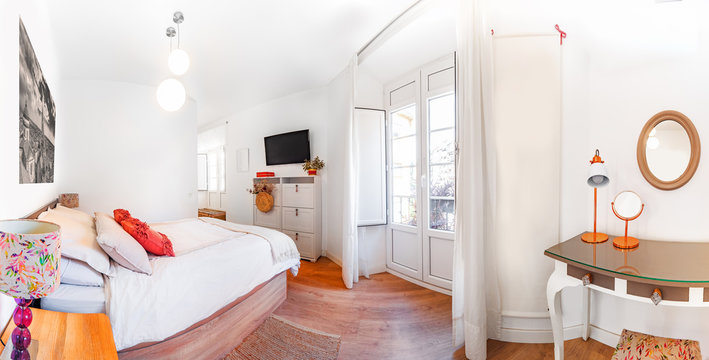 Panorama Of A Clean Bright Bedroom With King Size Bed, Duvet,nightstands, Lamps, Photography And A Tv. Minimalist White Stylish Interior