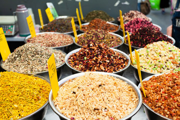 Various fruit teas on the counter in the market.