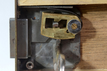 Obraz na płótnie Canvas Closeup into a lock mechanism of a lever tumbler lock (front cover removed). This key fits, and the tumblers allow the opening of the lock.