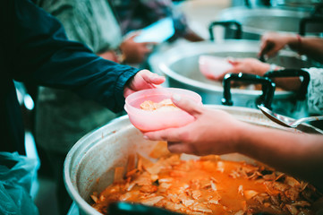 Feeding the poor to hands of a beggar, Poverty concept