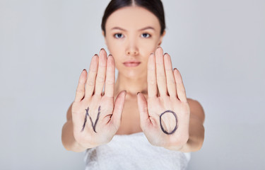 A strict serious young Asian woman says NO.