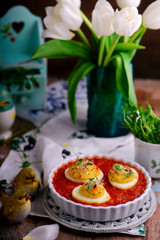 Baked Easter eggs in tomato sauce.style rustic.