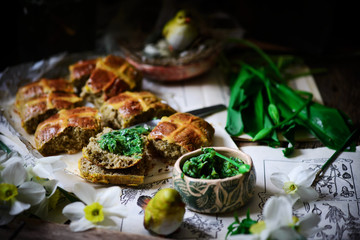 Fototapeta na wymiar savoury cheddar and wild garlic hot cross buns..traditional easter pastries.