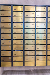 Metallic mailbox array in lobby of condominium building
