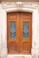 Paris, an old wooden door, with a head carved on the lintel, typical building in the Marais