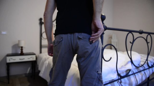 Caucasian man taking off his condom for a safe sex