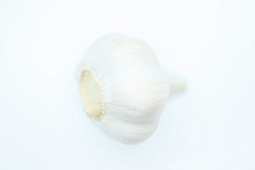 Garlic head located on a white background