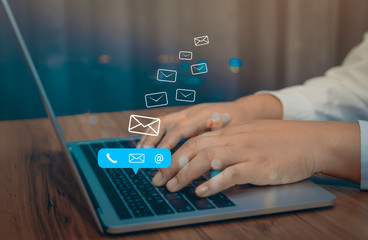 Contact us or Customer support hotline people connect. Businessman using a laptop computer with the (email, call phone, mail) icons.