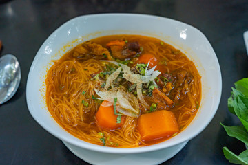 Bowl of Vietnamese braised beef rice noodles in restaurant