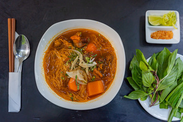Vietnam stewed beef brisket rice noodles served with basil