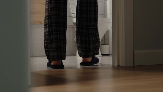 Aged man stands in a toilet a long time