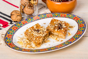 Oriental dessert baklava on a plate with a pattern