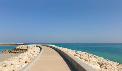 The bulk road to the sea. Sunny day on the coast.