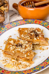 Oriental dessert baklava on a plate with a pattern